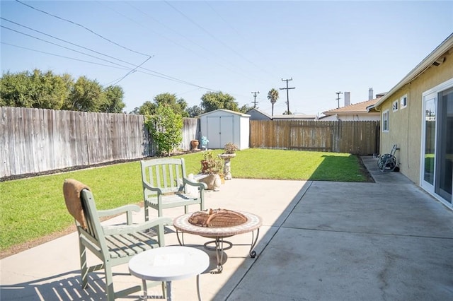 view of patio featuring a shed and a fire pit