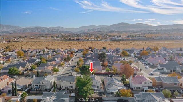 birds eye view of property with a mountain view