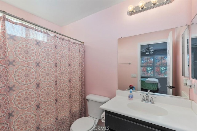 bathroom with ceiling fan, vanity, and toilet