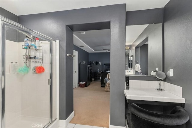 bathroom featuring tile patterned floors, vanity, and an enclosed shower