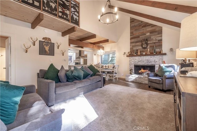 living room featuring a brick fireplace, high vaulted ceiling, beamed ceiling, hardwood / wood-style floors, and a chandelier