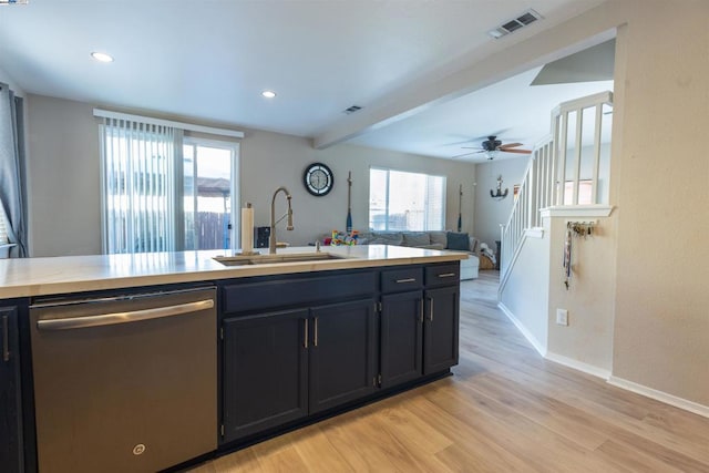 kitchen with ceiling fan, dishwasher, beam ceiling, sink, and light wood-type flooring