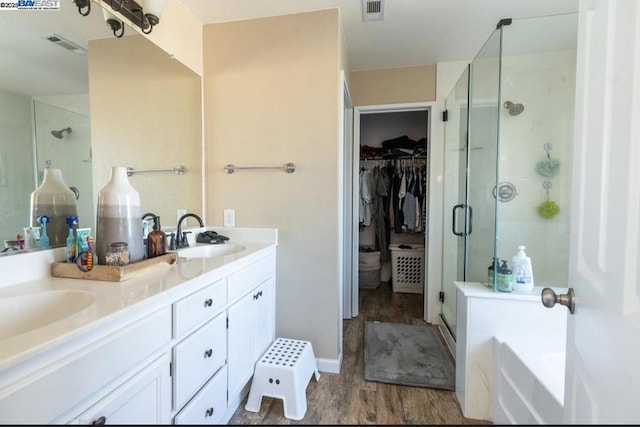 bathroom with separate shower and tub, hardwood / wood-style floors, and vanity