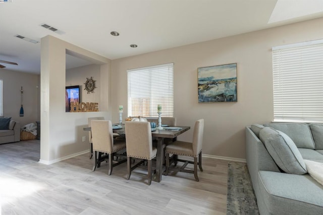 dining space featuring ceiling fan and light hardwood / wood-style flooring