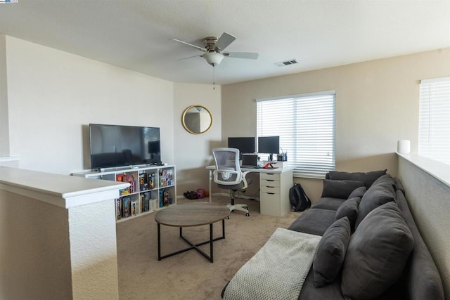 living room featuring ceiling fan and light carpet