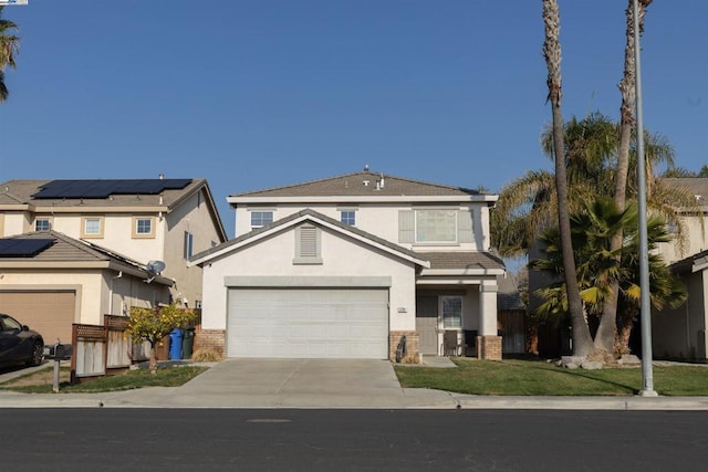 view of front facade featuring a garage and solar panels