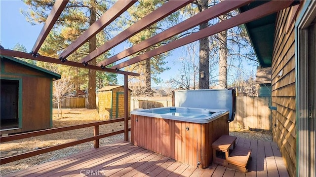 wooden terrace with a pergola, a hot tub, and a storage shed