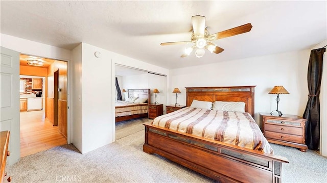 bedroom with a closet, a ceiling fan, and light colored carpet