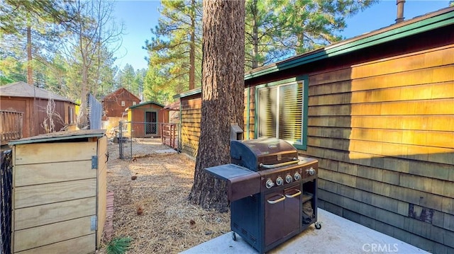 exterior space with a grill and a storage shed