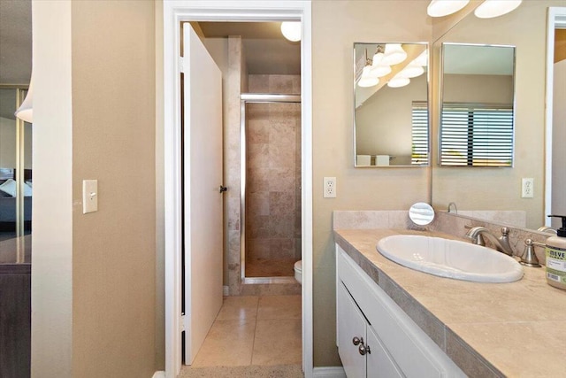 bathroom with tile patterned floors, toilet, vanity, and walk in shower