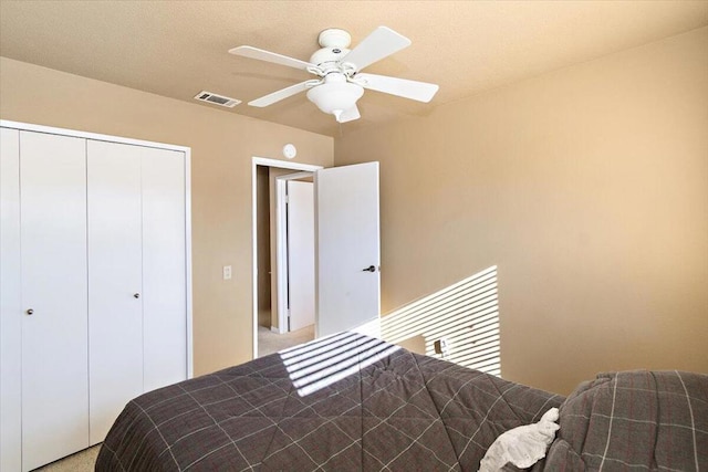 carpeted bedroom featuring a closet and ceiling fan