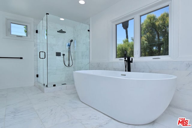 bathroom with separate shower and tub