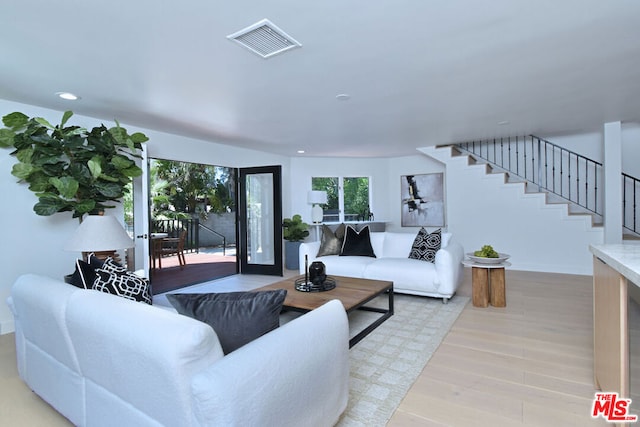 living room featuring light hardwood / wood-style floors and french doors