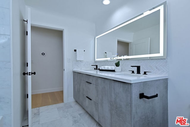 bathroom featuring decorative backsplash and vanity