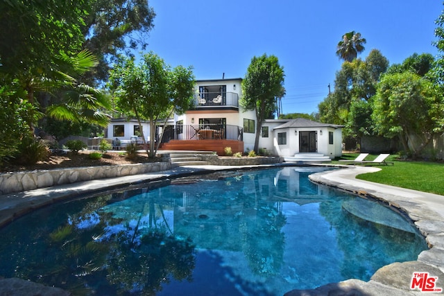 view of pool with a wooden deck