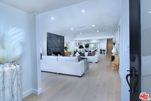 living room with light wood-type flooring and a fireplace