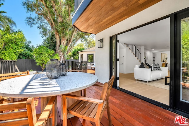 wooden terrace featuring outdoor lounge area