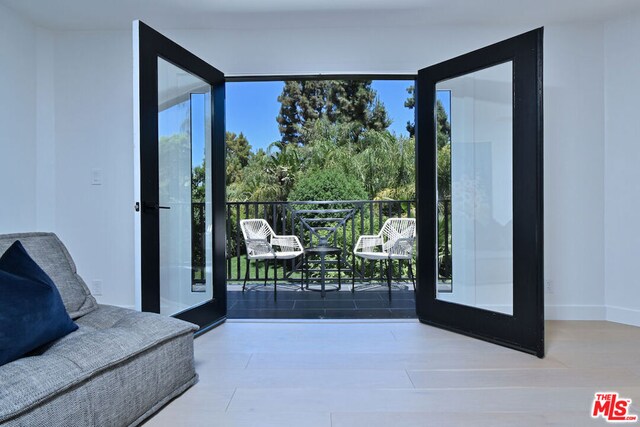 entryway featuring wood-type flooring and french doors