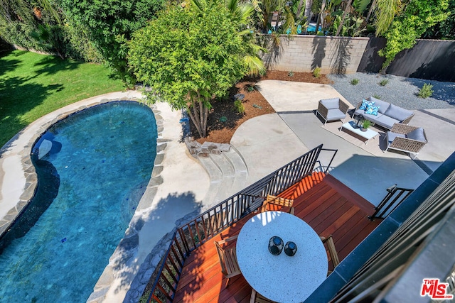 view of pool featuring an outdoor living space and a patio area