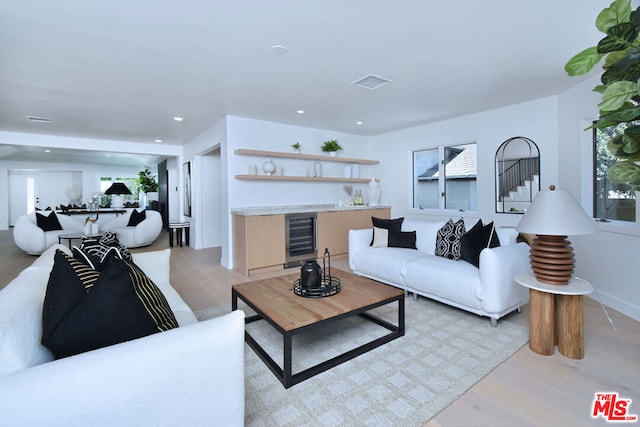 living room featuring light hardwood / wood-style flooring and beverage cooler