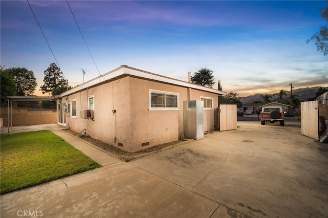 property exterior at dusk with cooling unit