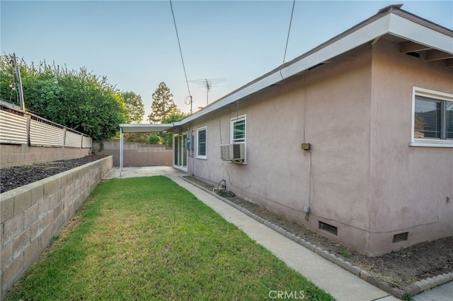 view of side of home with a yard and cooling unit