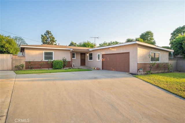 single story home featuring a garage and a front yard