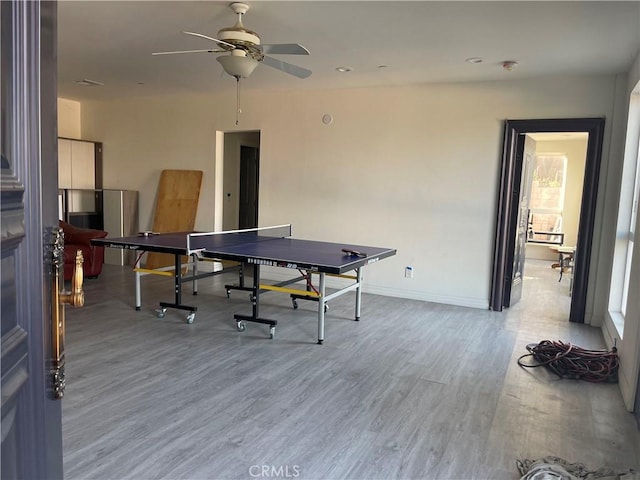 playroom with ceiling fan and light hardwood / wood-style floors