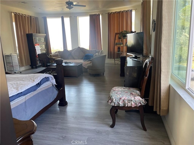 bedroom with ceiling fan and wood-type flooring