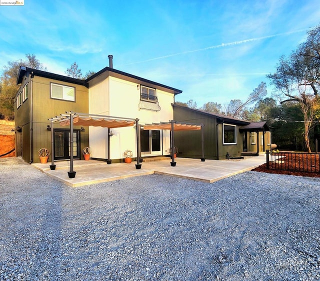 rear view of house with a pergola, a patio, and french doors