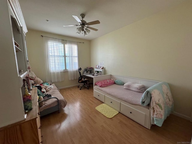 bedroom with light hardwood / wood-style floors and ceiling fan