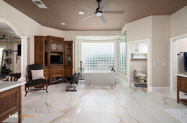 9120 Laramie Ave, Bakersfield, CA 93314 - bathroom featuring vanity, a bathing tub, ceiling fan, toilet, and ornate columns