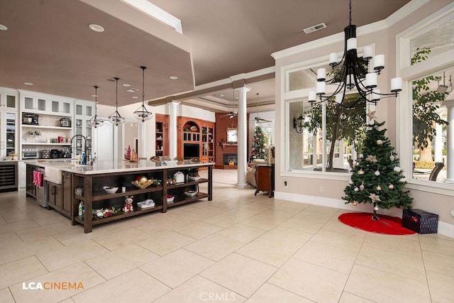 9120 Laramie Ave, Bakersfield, CA 93314 - kitchen with dark brown cabinets, decorative light fixtures, plenty of natural light, and decorative columns