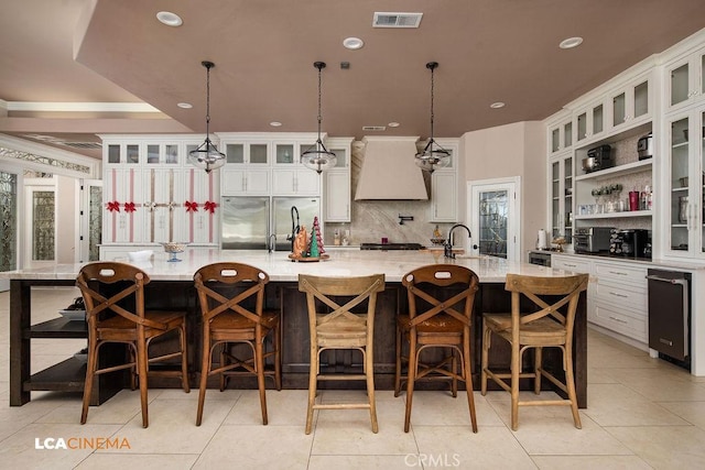 9120 Laramie Ave, Bakersfield, CA 93314 - kitchen with pendant lighting, a kitchen bar, premium range hood, and a large island with sink