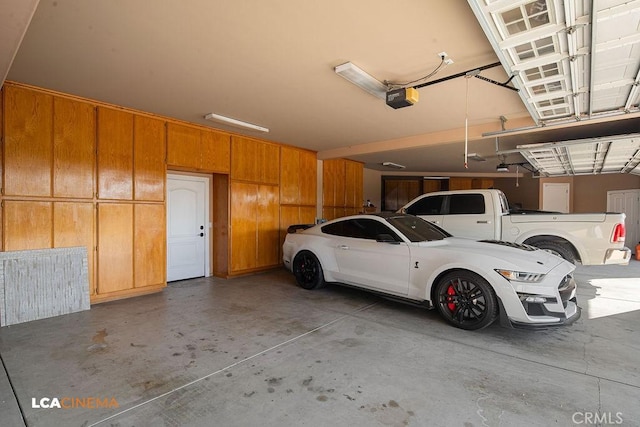9120 Laramie Ave, Bakersfield, CA 93314 - garage featuring a garage door opener and wood walls