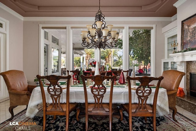 9120 Laramie Ave, Bakersfield, CA 93314 - dining space with tile patterned floors, a raised ceiling, a fireplace, and a chandelier