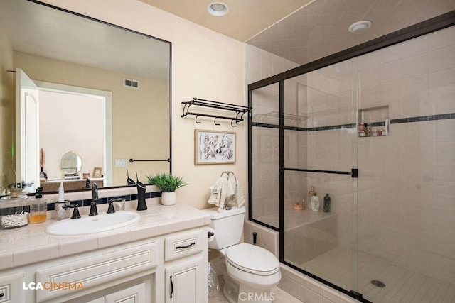 9120 Laramie Ave, Bakersfield, CA 93314 - bathroom featuring vanity, toilet, and a shower with shower door