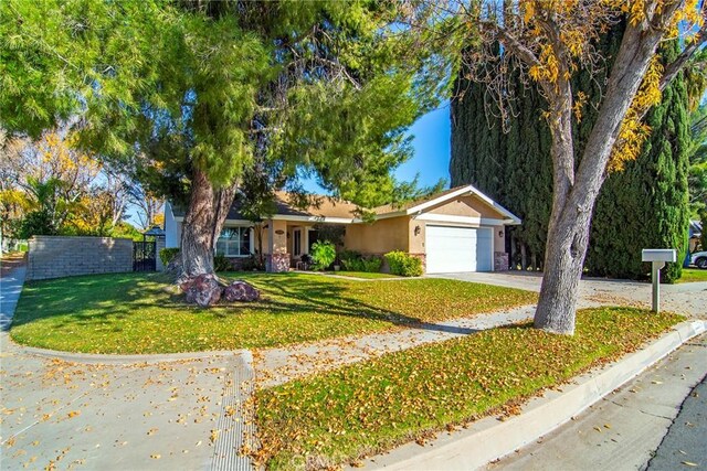 view of front of home with a front lawn and a garage