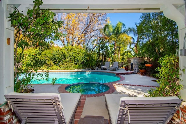 view of pool featuring an in ground hot tub and a patio