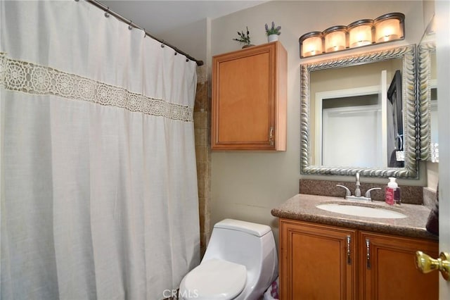 bathroom featuring vanity, toilet, and walk in shower