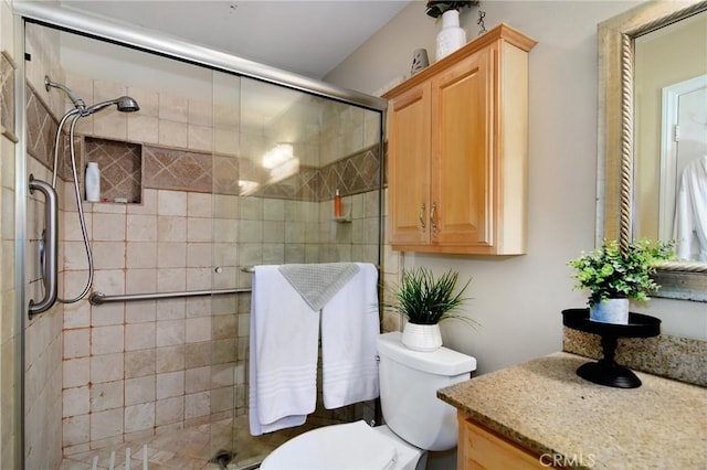 bathroom with vanity, an enclosed shower, and toilet