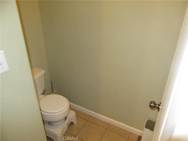 bathroom with tile patterned flooring and toilet