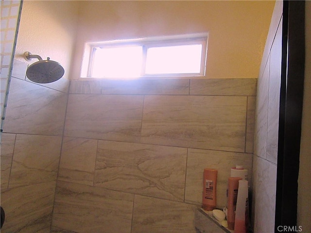 bathroom with a wealth of natural light and tiled shower