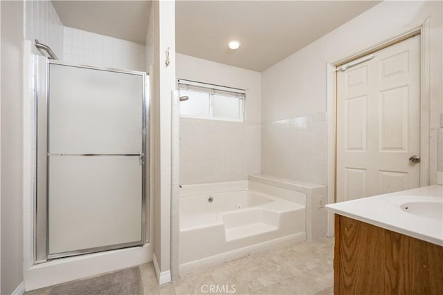 bathroom with vanity and shower with separate bathtub