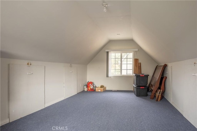 bonus room with lofted ceiling and carpet floors