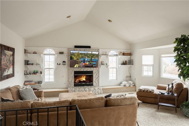 living room featuring carpet flooring, a high end fireplace, and vaulted ceiling