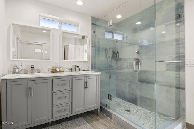 bathroom with vanity, wood-type flooring, and an enclosed shower