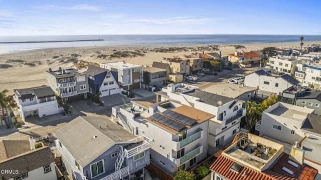 bird's eye view featuring a water view and a view of the beach