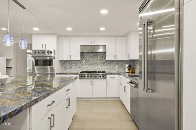 kitchen featuring decorative backsplash, decorative light fixtures, light hardwood / wood-style floors, white cabinetry, and stainless steel appliances