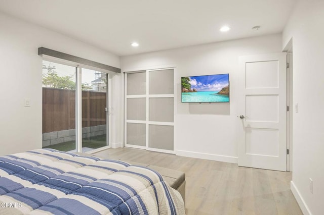 bedroom featuring wood-type flooring and access to outside